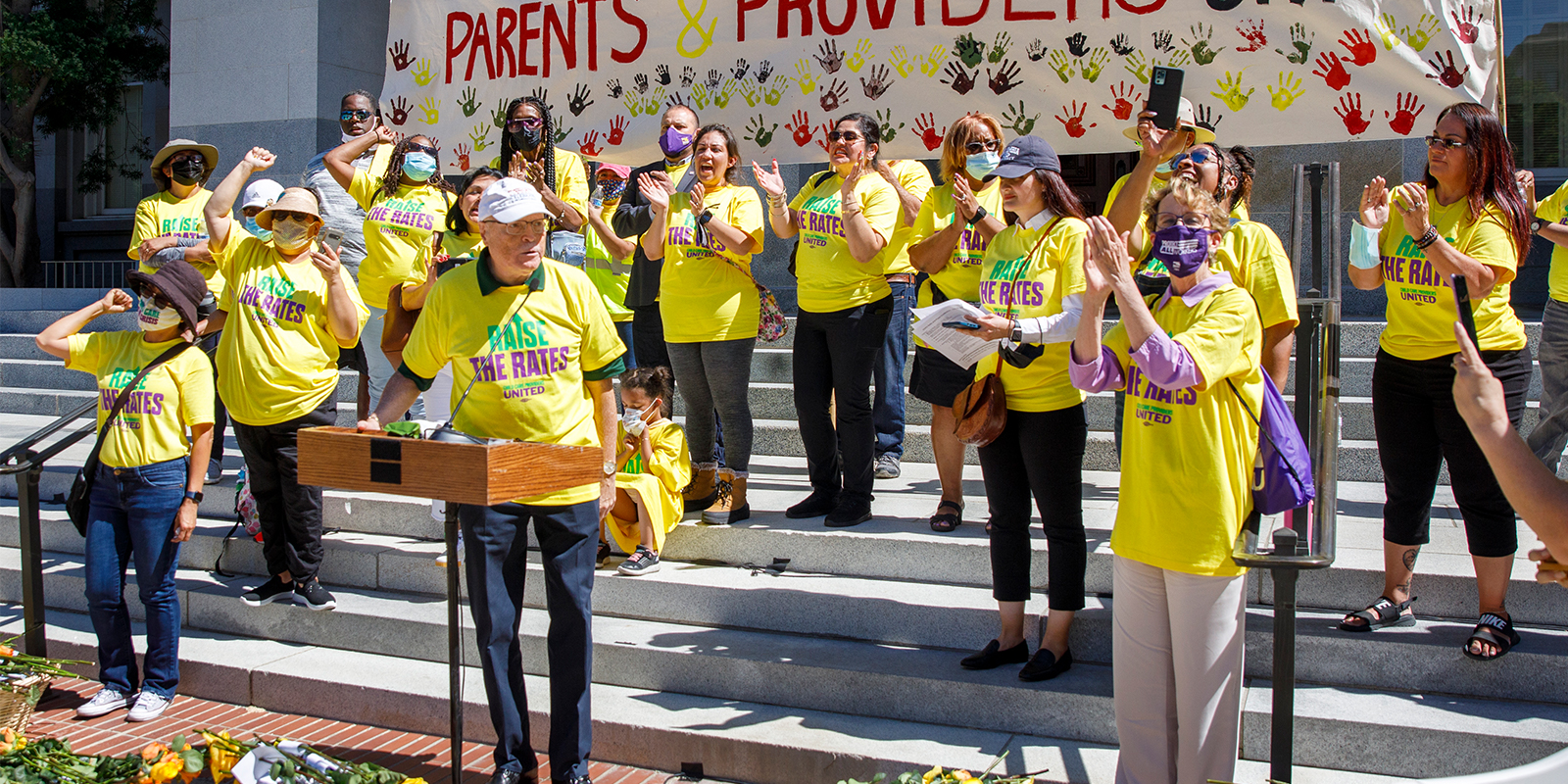 400 child care providers deliver roses and demand fair pay from governor