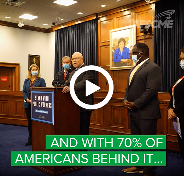 AFSCME President Lee Saunders speaks in front of a podium. There is a play button over image.